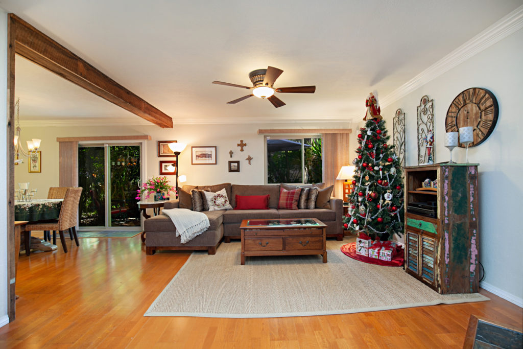 brown sofa and christmas tree in living room