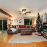 brown sofa and christmas tree in living room