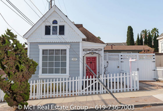 grey and white vintage house with red front door - white picket fence