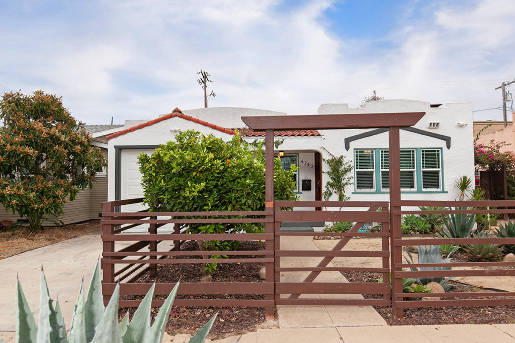 wood fence in front of landscape and front of Spanish Style Home in City Heights