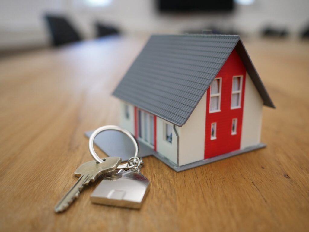 a key chain and a small model of a house.