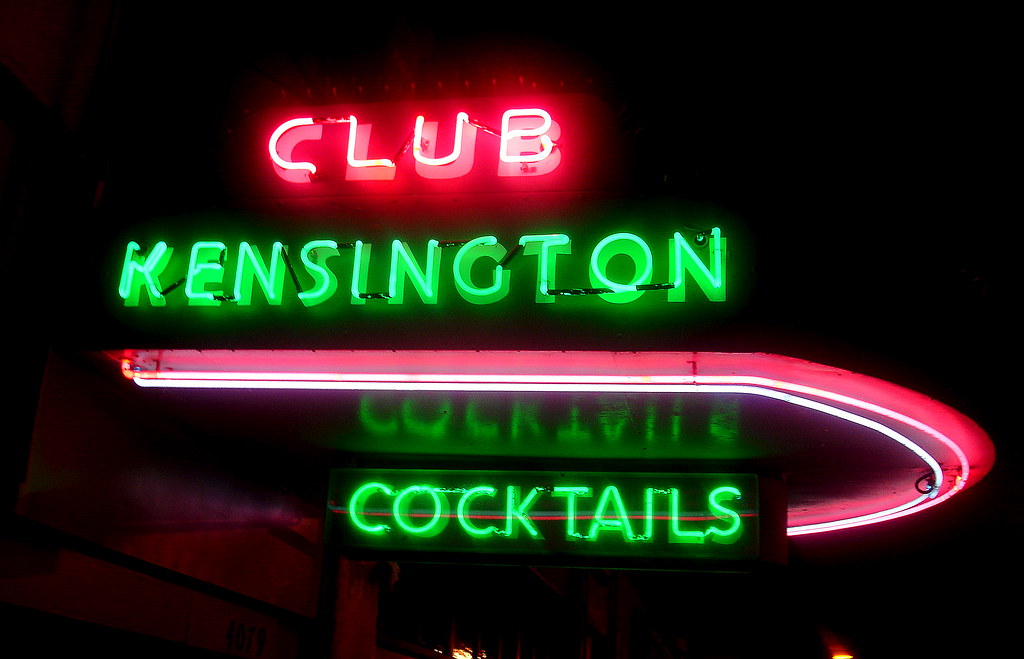 neon lights showing club kensington cocktails