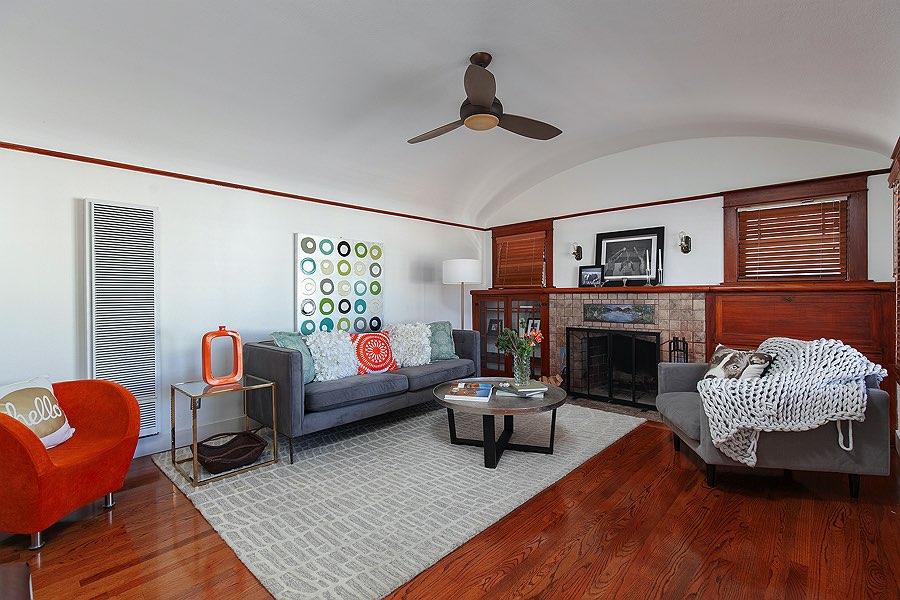 Grey sofa and bright accessories in light colored living room