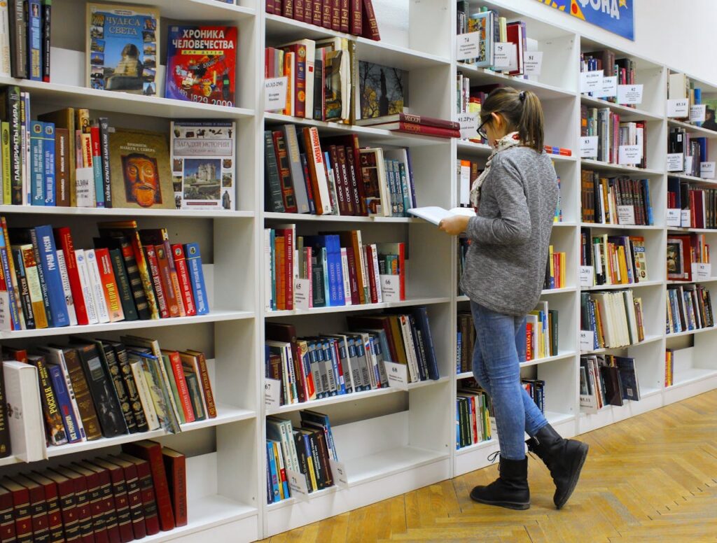 A Woman Reading a Book in A Library