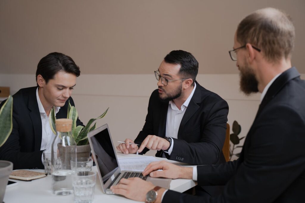 Men in Suits Discussing Paperwork