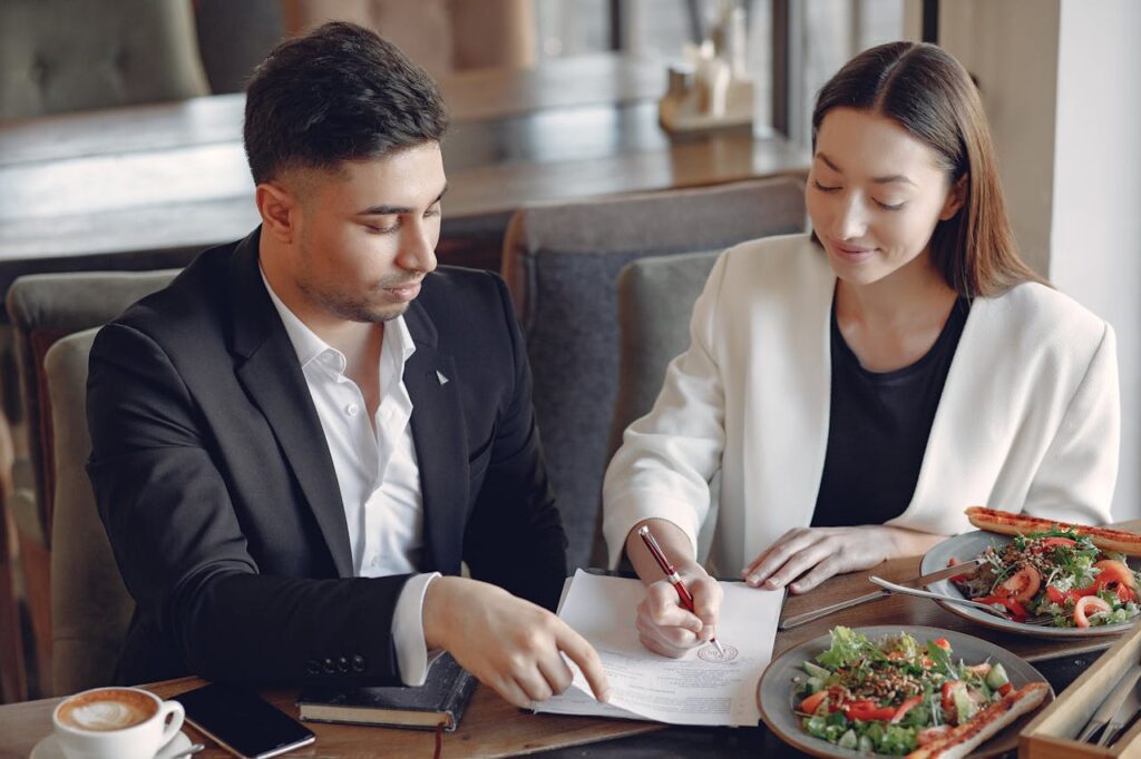 People on the Table Signing a Document