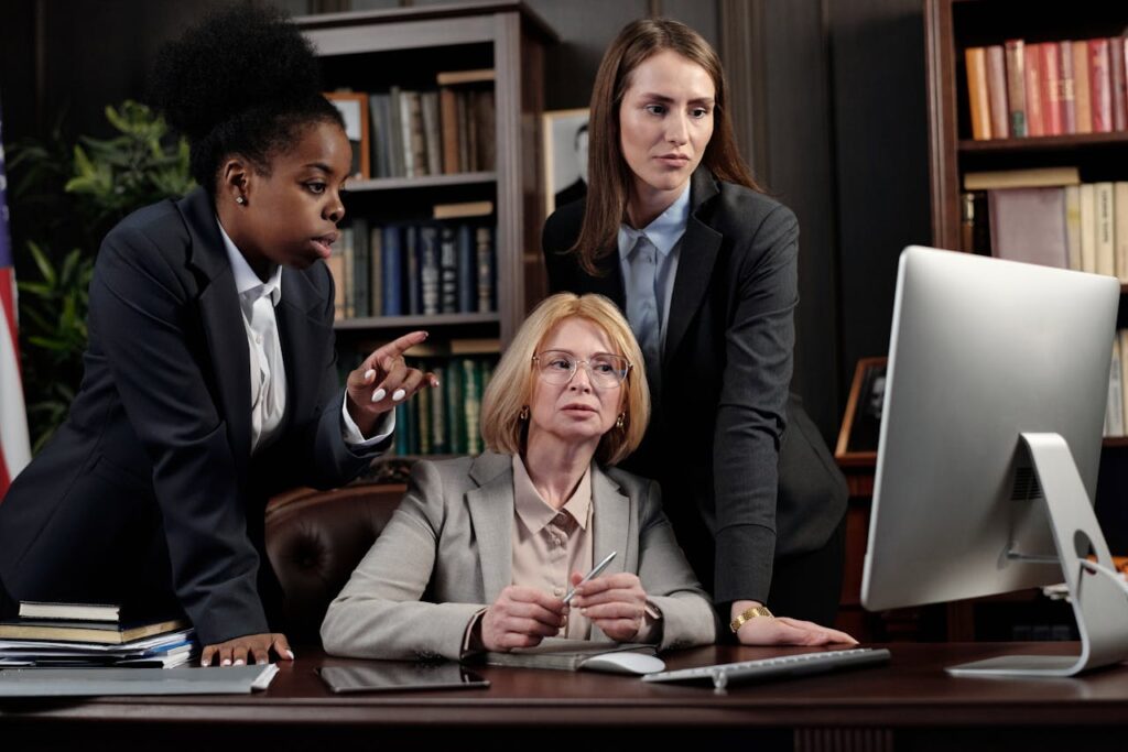 People in an Office Discussing infront of a Computer