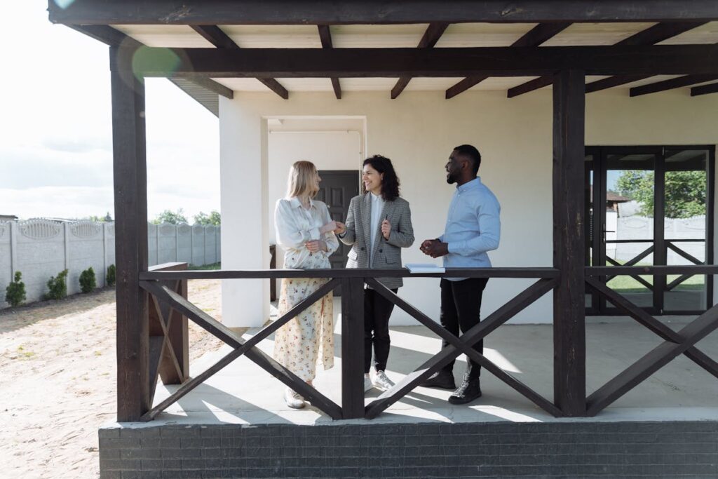 An Agent Talking to a Couple while on the Porch