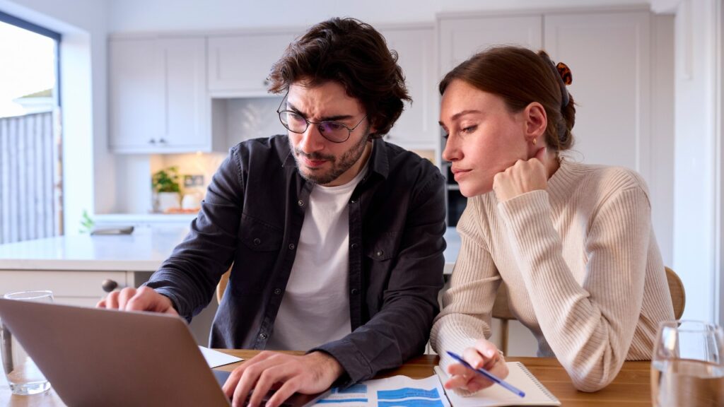 A Couple Looking Worried Infront of a Computer
