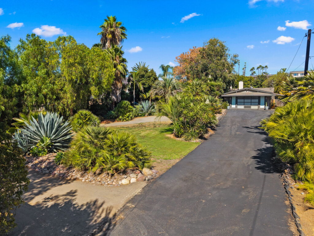 entry long driveway with view of the garage