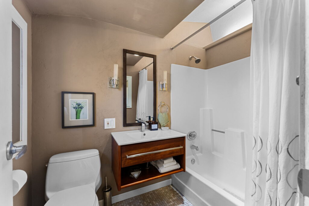 bathroom with brown vanity and tub