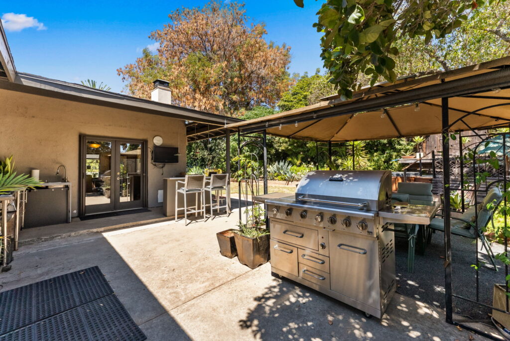 French Doors on side of home and outdoor furniture and bbq