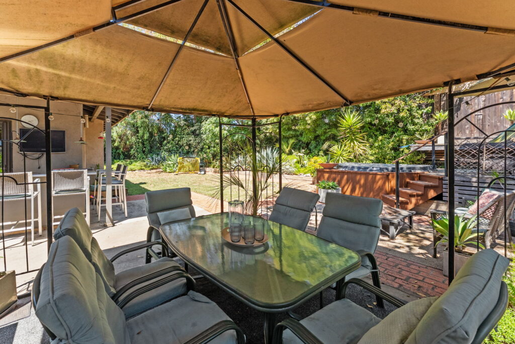 outdoor table and chairs under a large outdoor umbrella