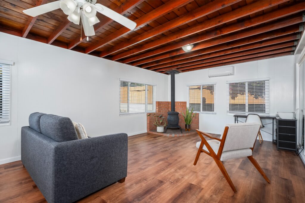 Sun-filled bonus room at 2170 Montclair St North Park with exposed Knotty Pine ceilings and antique potbelly stove.