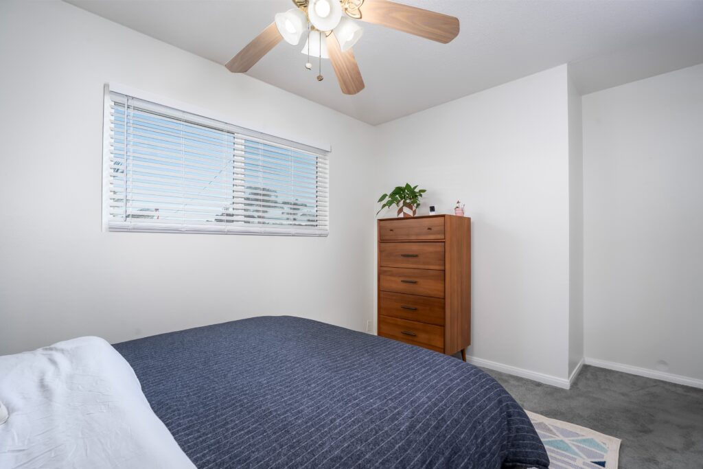 Sun-drenched bedroom interior at 2170 Montclair St showing double-pane vinyl windows and natural light typical of North Park real estate.